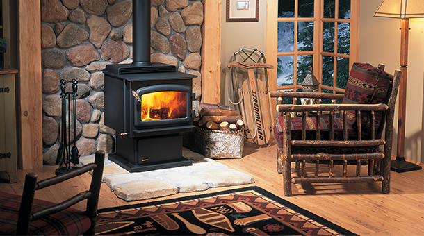 Regency Classic F2400 Medium Wood Stove with western chair to the right a sled accessories