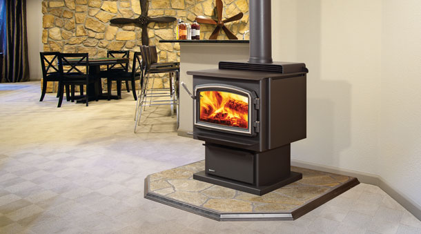 Regency Classic™ F3100 Large Wood Stove with flames and table chairs and bar stools in background