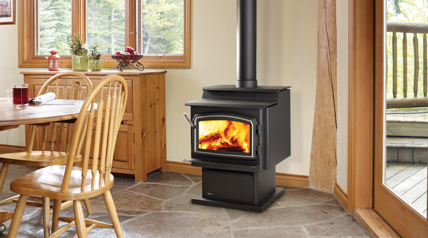 Regency Classic™ S2400 Medium Step Top Wood Stove with windows to the right and left along with a breakfast table