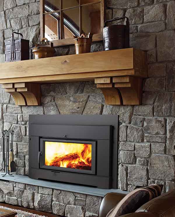 CI2700-1 Wood Low Profile Fireplace with wood and accessories to the left and candles to the right - coffee table in the middle snow outside